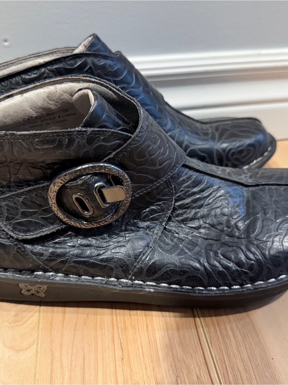 Alegria Black Embossed Leather Ankle Booties with Decorative Buckle